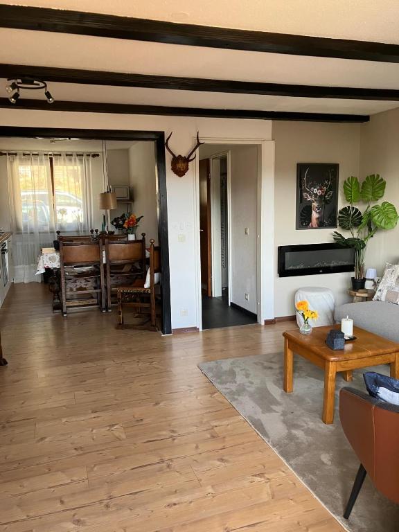 a living room with a couch and a table at Haus am Waldrand in Todtmoos