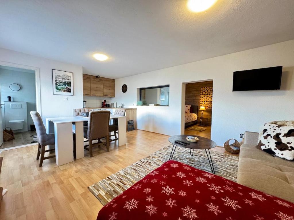 a living room with a couch and a table at Havre de paix 1 in Grône