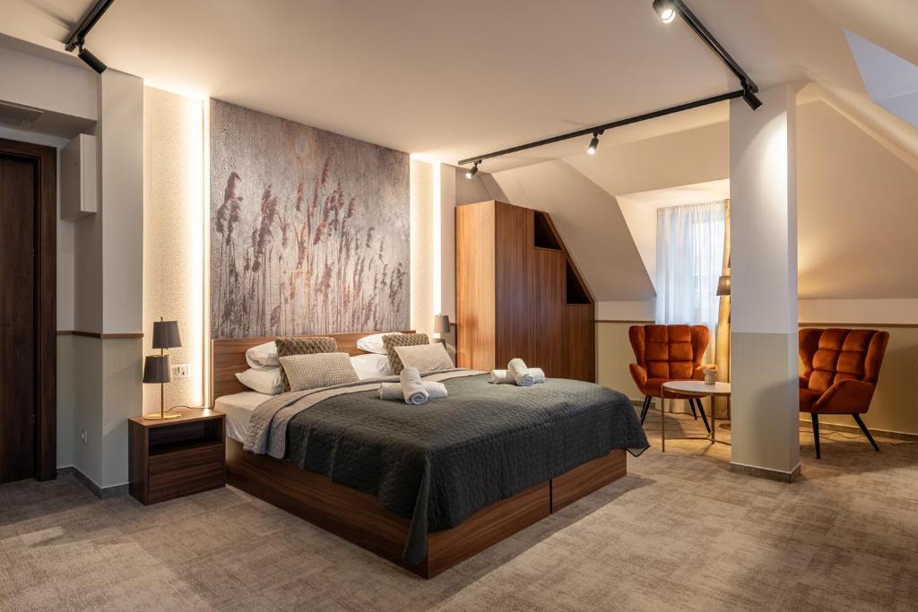 a bedroom with a bed and a table and chairs at Dolce Vita Hotel Art in Budapest