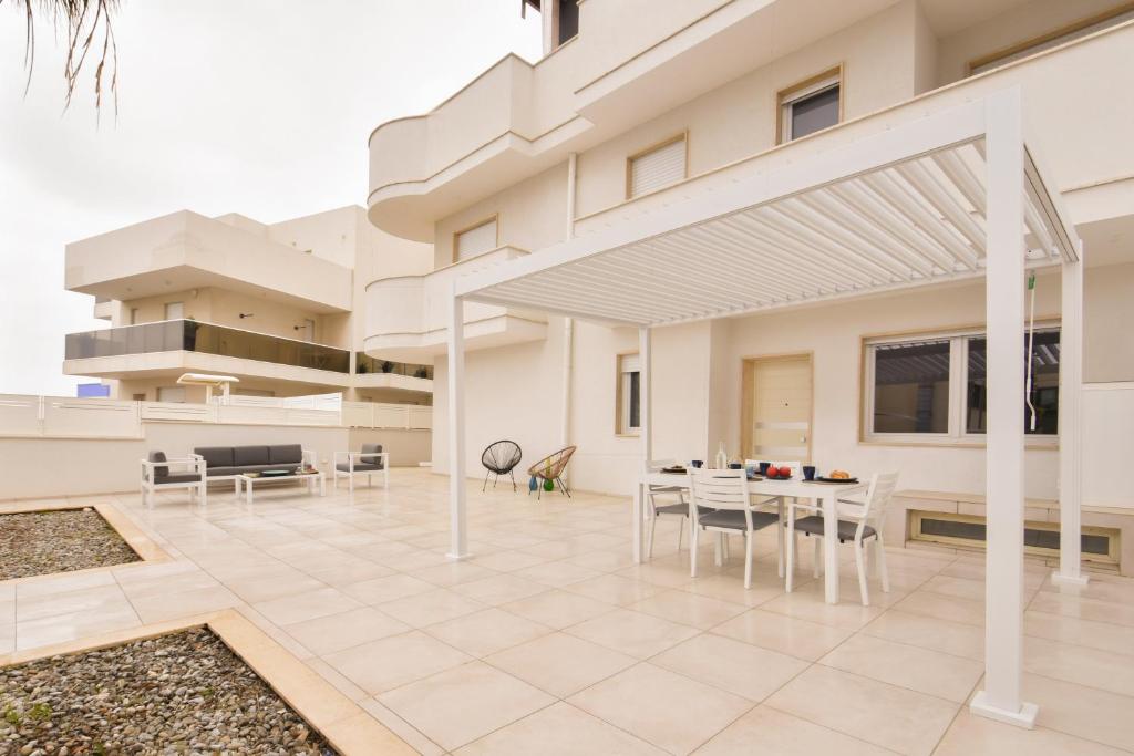 a house with a patio with a table and chairs at LifeStyle Boutique Apartment in Monopoli