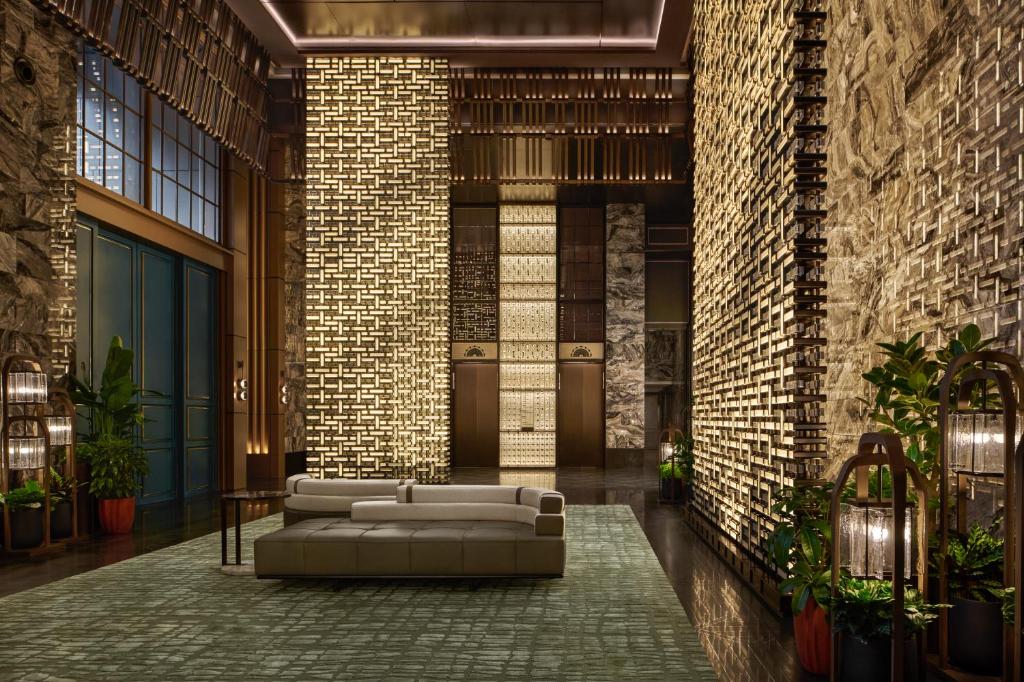 a living room with a couch and a brick wall at Andaz Shanghai ITC in Shanghai