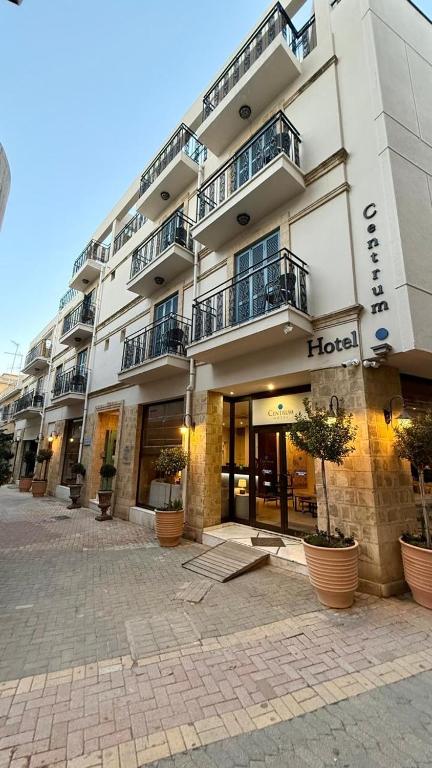 a hotel building with plants in front of it at Centrum Hotel - City Center in Nicosia