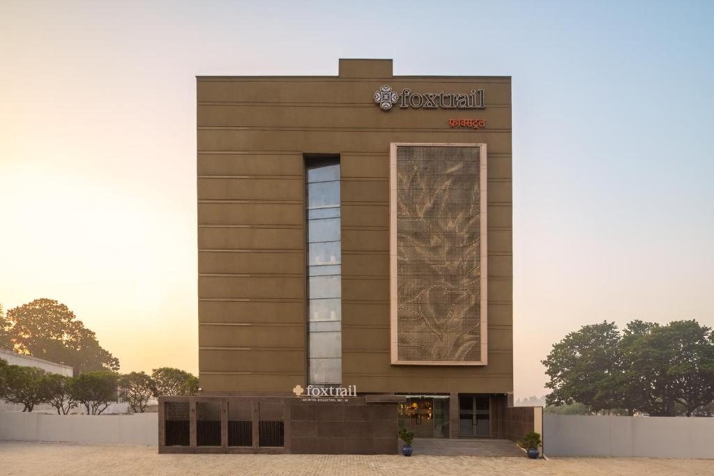 a brown building with a sign on it at Foxtrail Sector 60 - AM Hotel Kollection, Gurgaon in Gurgaon