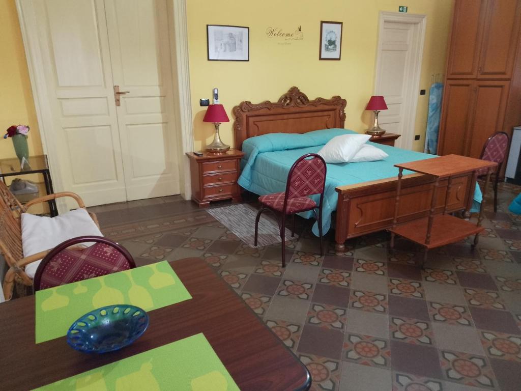 a bedroom with a bed and a table and chairs at B&B Donna Elvira in Siderno Marina