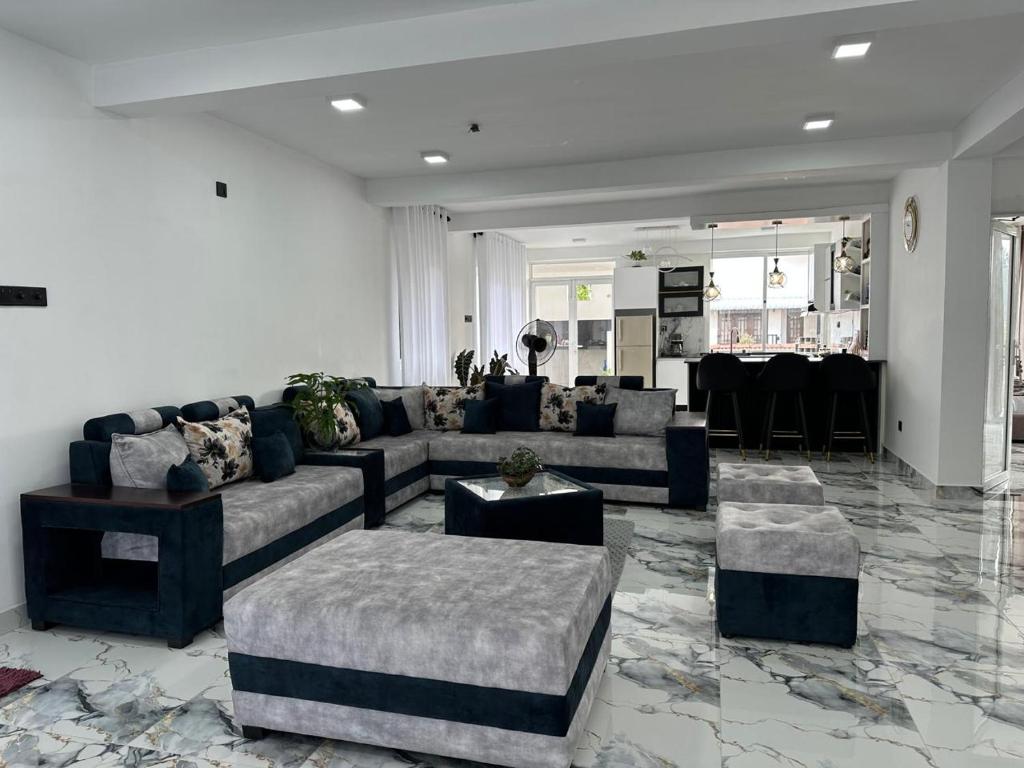 a large living room with couches and a table at The calm villa in Kandana