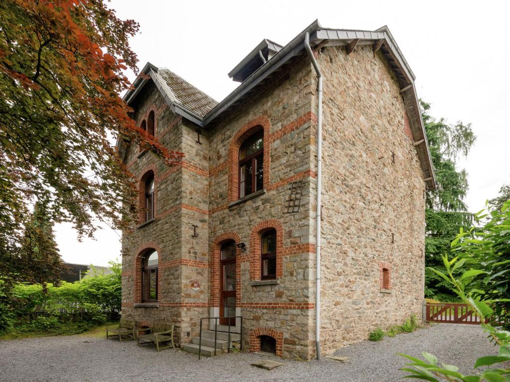 an old brick building with red bricks on it at A beautifully renovated mansion in the Ardennes in Vielsalm