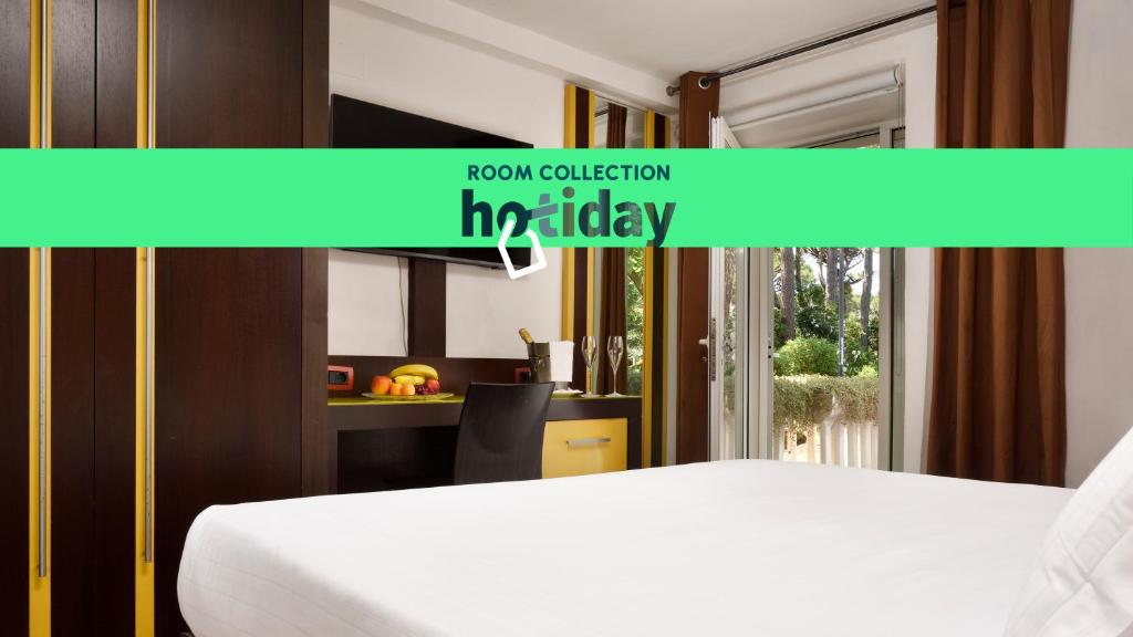 a bedroom with a white bed and a window at Hotiday Marina di Bibbona in Marina di Bibbona