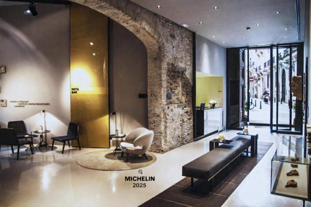 a lobby with a couch and chairs in a building at Caro Hotel in Valencia