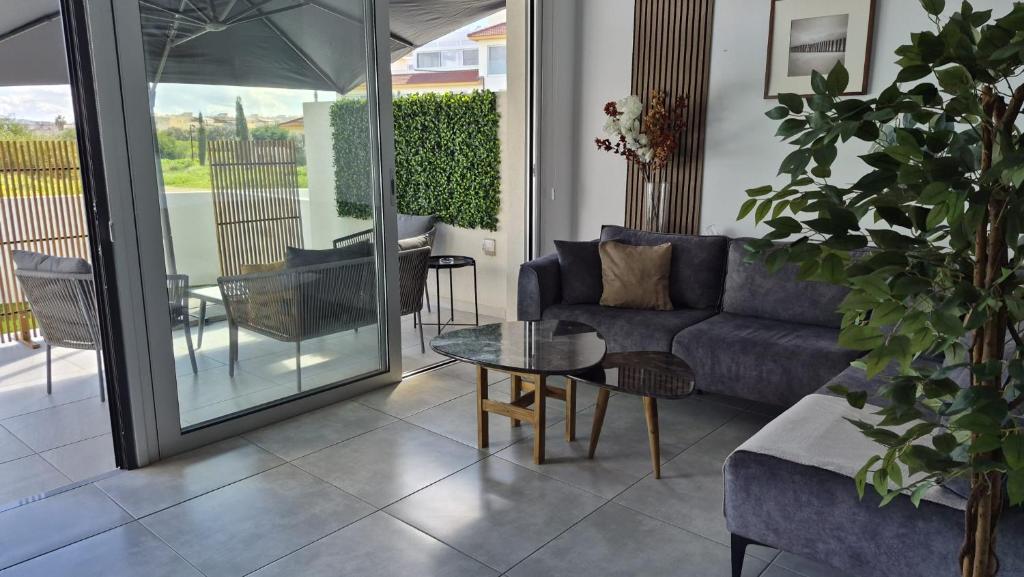 a living room with a couch and a table at Protaras Heights- Hana in Paralimni