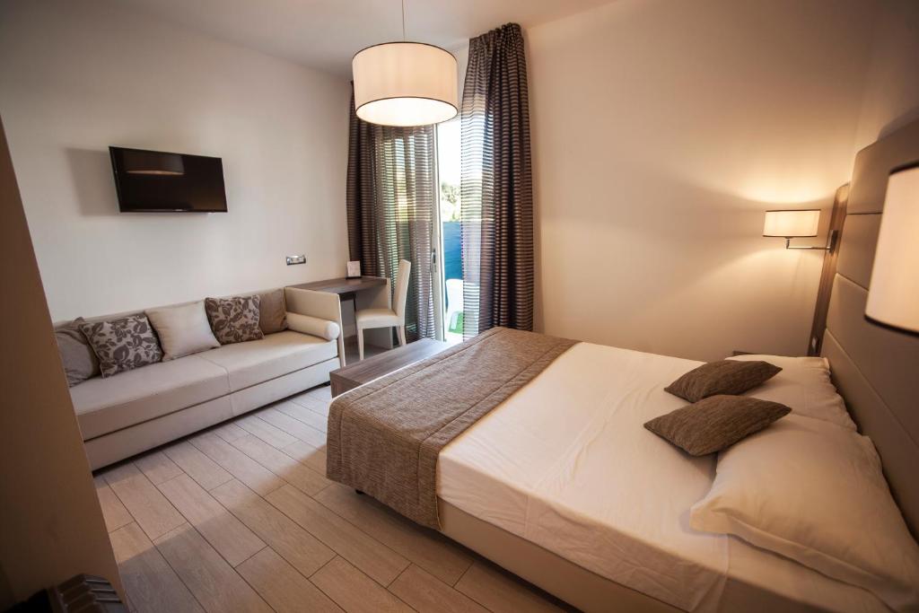 Postel nebo postele na pokoji v ubytování Hotel Pineta Mare