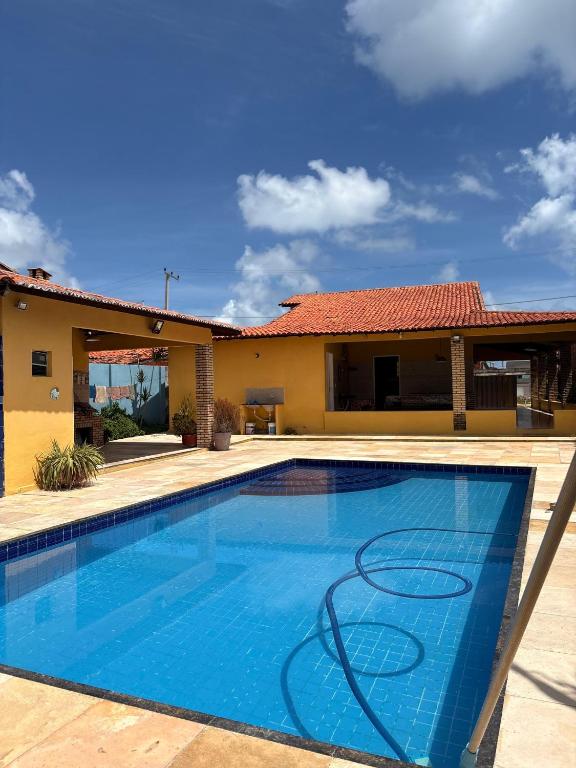 a swimming pool in front of a house at Caponga Beach House - 100m da Praia in Cascavel