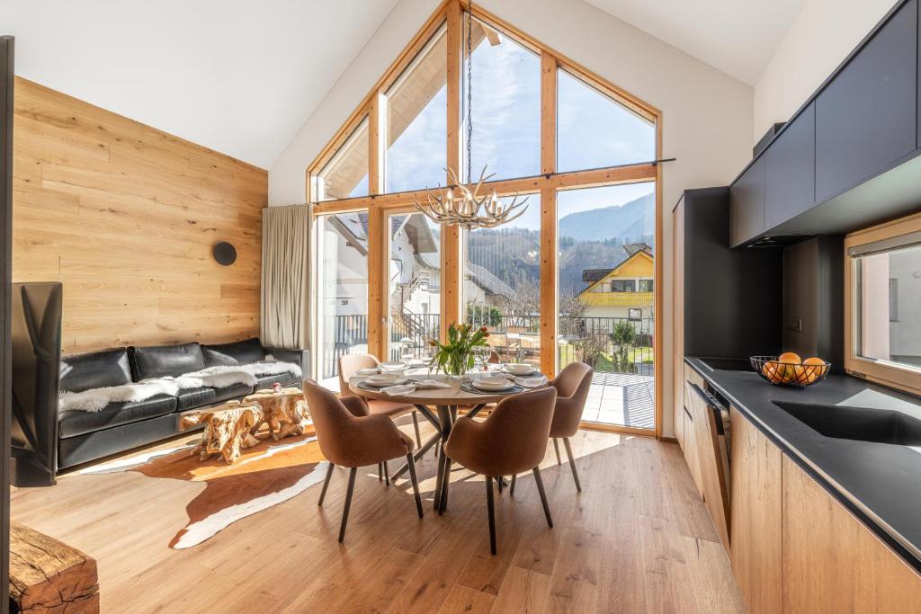 a kitchen and dining room with a table and chairs at Chalet Bela in Bohinjska Bela