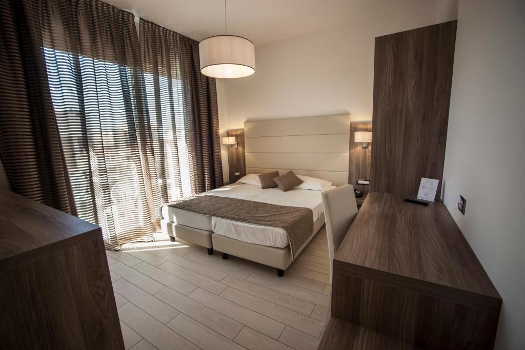 Postel nebo postele na pokoji v ubytování Hotel Pineta Mare