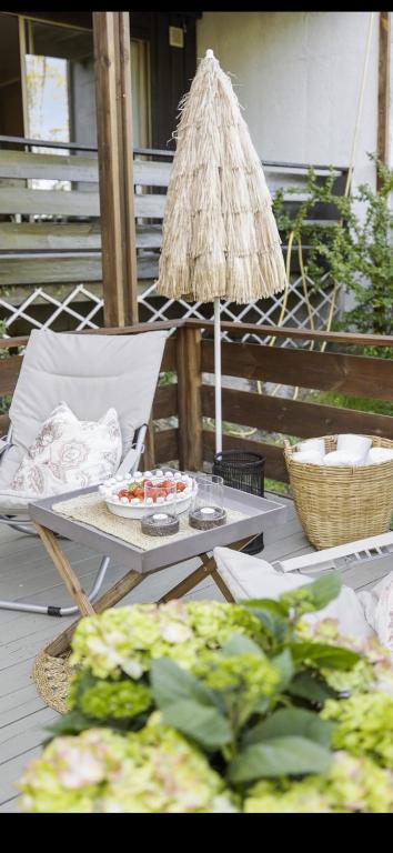 a table with a chair and a table with food on it at Stavern Terrace in Larvik
