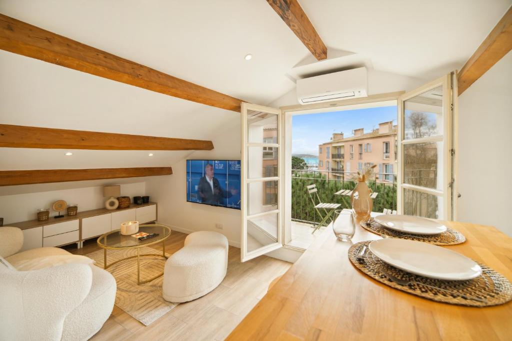 a living room with white furniture and a large window at Saint Tropez High standing 3 in Saint-Tropez