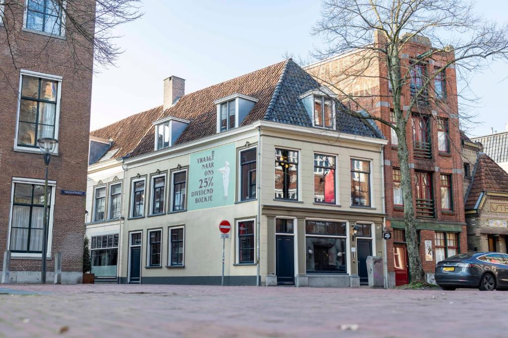 a white building with a stop sign in front of it at Bakery Boutique Hotel in Leeuwarden