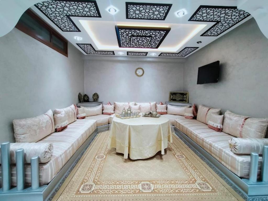 a living room with a large couch and a table at riad dar bassou in Adrouine