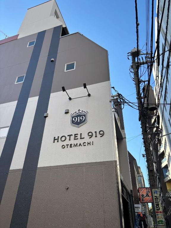 a hotel sign on the side of a building at HOTEL919Otemachi in Hiroshima