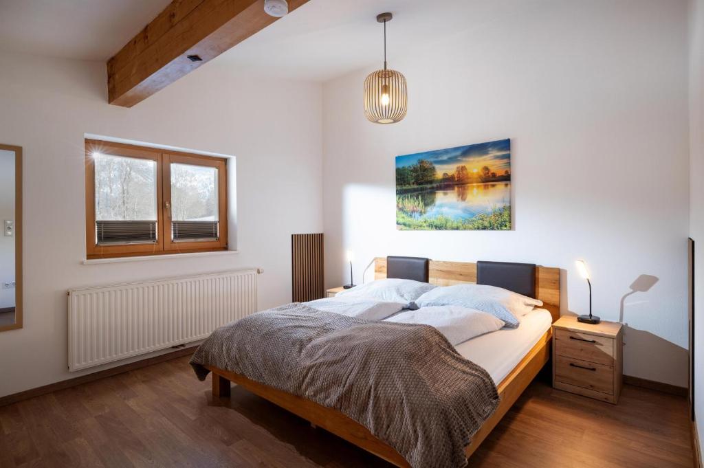 a bedroom with a large bed and a window at Harry's Hittn in Söll