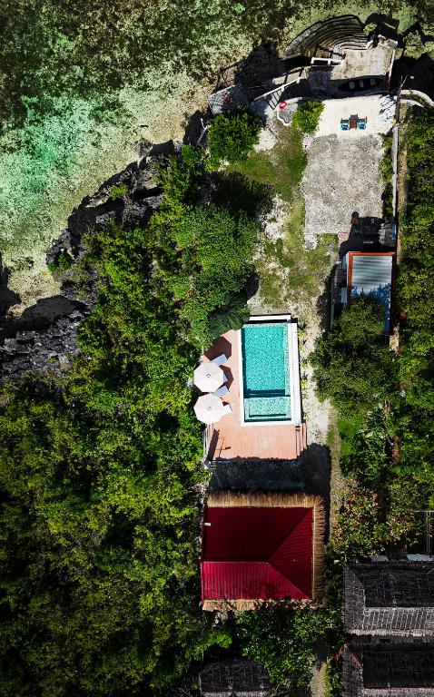 an overhead view of a swimming pool in a yard at Uzuri Kubo Huts in Moalboal