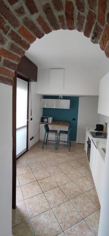 a kitchen with a table and a table at SISTERS GUEST HOUSE 2 in Somma Lombardo