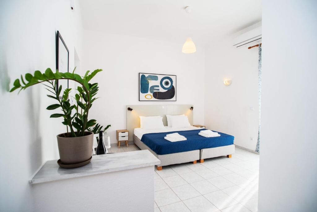 a bedroom with a bed and a potted plant at Fardini Resorts in Kavos