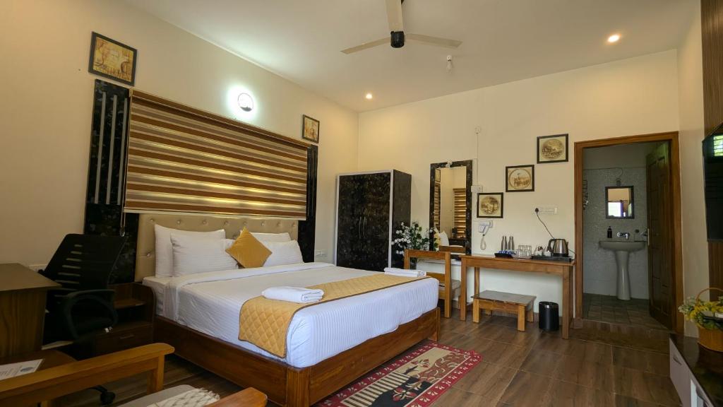 a bedroom with a bed and a desk in it at Advaya Luxury Resort, Sakleshpur in Sakleshpur