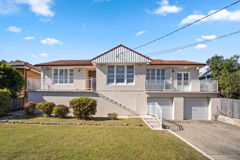 a large white house with a yard at Fairlight Luxe Escape 4BR with Parking in Killara