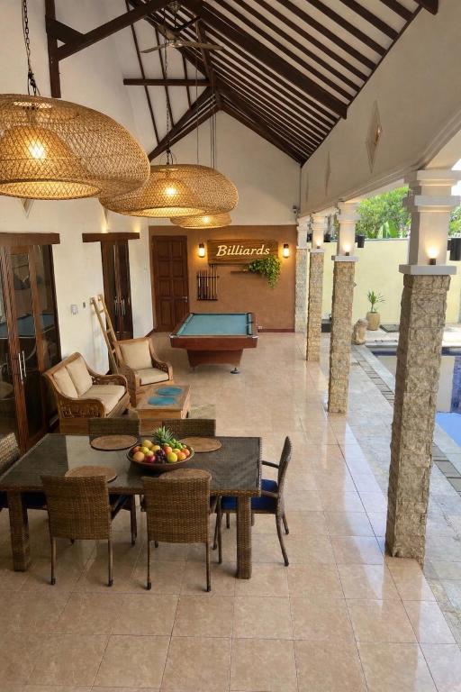 a living room with a ping pong table and a pool at Villa Stella Garden in Senggigi
