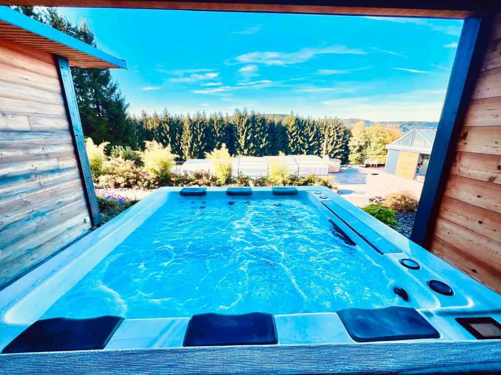 a swimming pool in the backyard of a house at La lisière romantique in Granges-Aumontzey