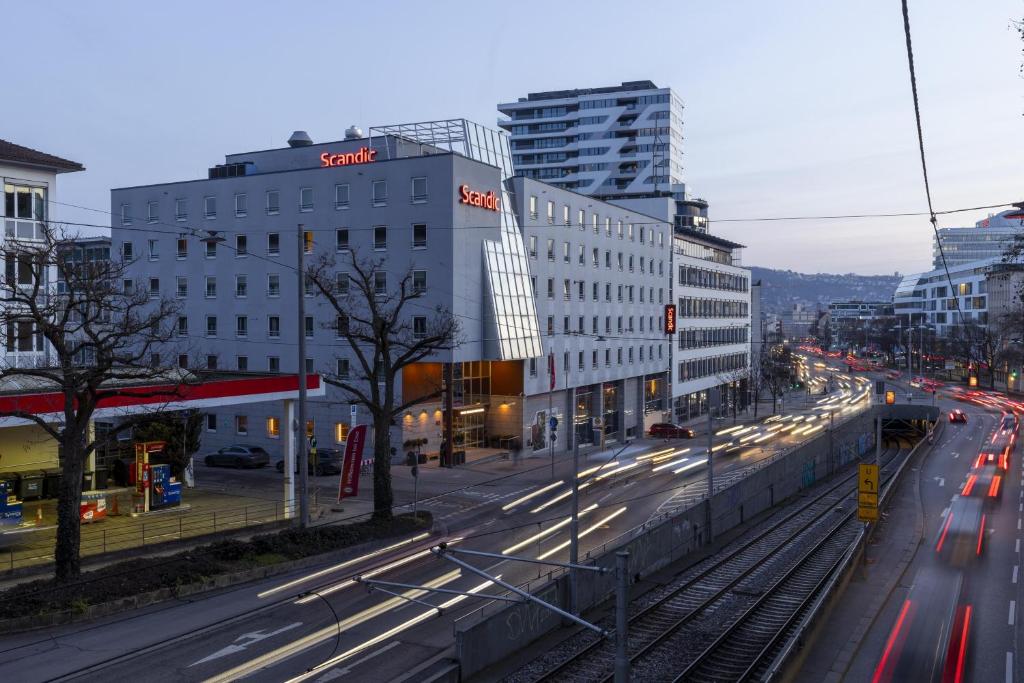 a busy city street with buildings and cars on the road at Scandic Stuttgart Europaviertel in Stuttgart