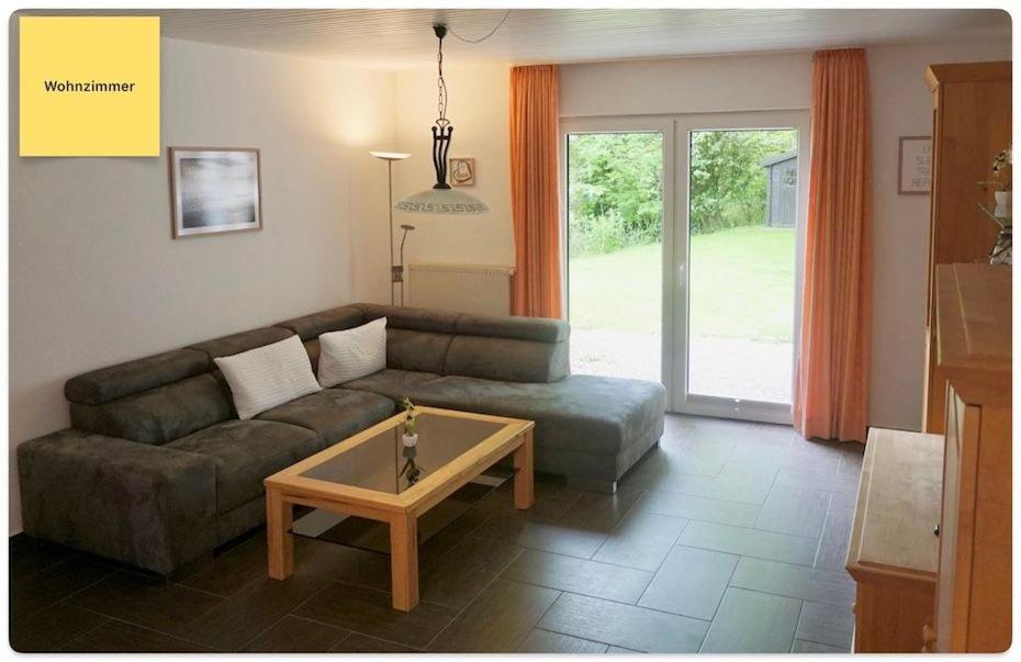 a living room with a couch and a coffee table at Huus Negen in Neuharlingersiel