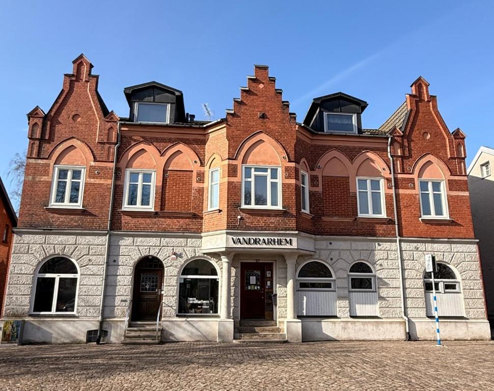 a large brick building with a red brick at Torget Vandrarhem in Kävlinge