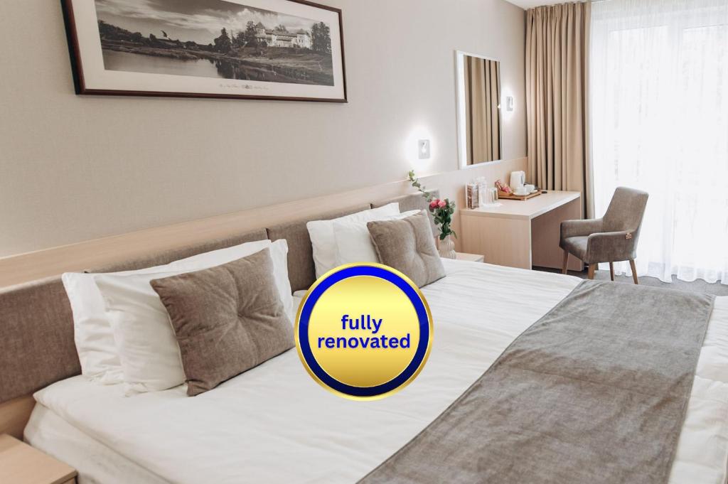 a hotel room with a bed with a blue circle at Nota Bene Hotel & Restaurant in Lviv