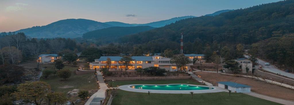 an aerial view of a house with a swimming pool at Vanasya Retreat Corbett in Amgarhi