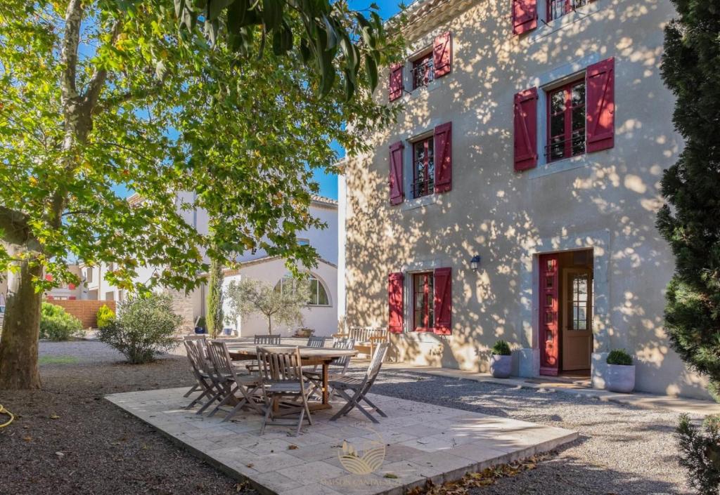 a table and chairs in front of a building at Maison Vigneronne-piscine et vignes in Trèbes
