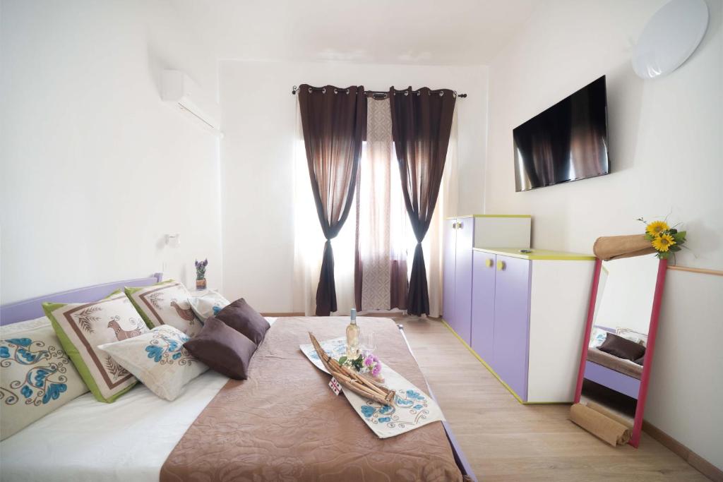 a bedroom with a bed with a table on it at CHIARAGIULIA Camera Giulia Cabras in Càbras