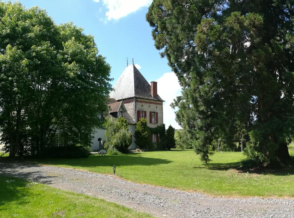an old house on a green field with trees at Chambres d'hôtes de Champendu in Azy-le-Vif