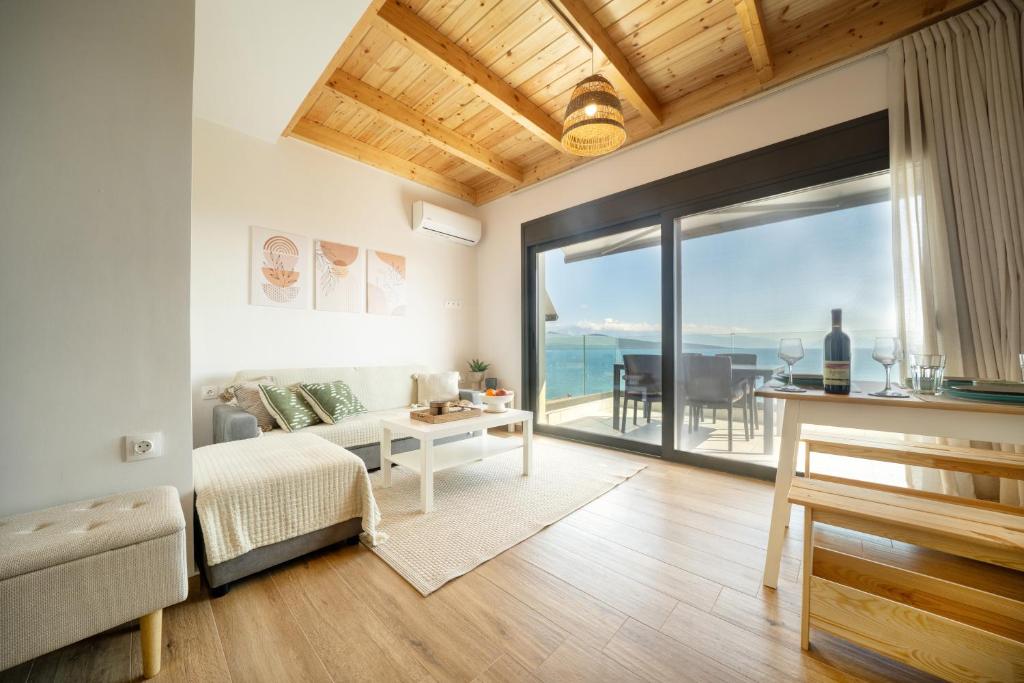 a living room with a view of the ocean at Emmari Luxury Suites in Episkopos
