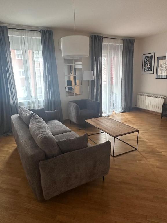 a living room with a couch and a table at Ada Corner in Belgrade