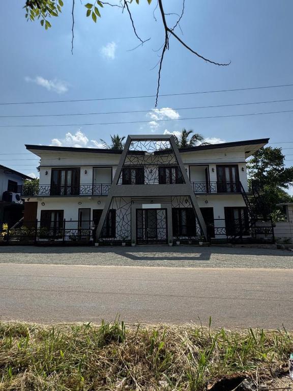 a large white building with a lot of windows at Muthugala Resort in Anuradhapura