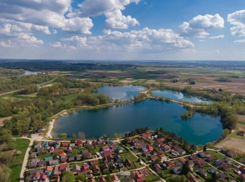 an aerial view of a village next to a lake at Biser jezera in Gornja Šuma