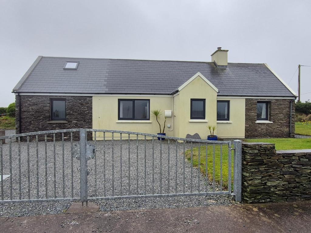 a house with a fence in front of it at Skellig View in Portmagee