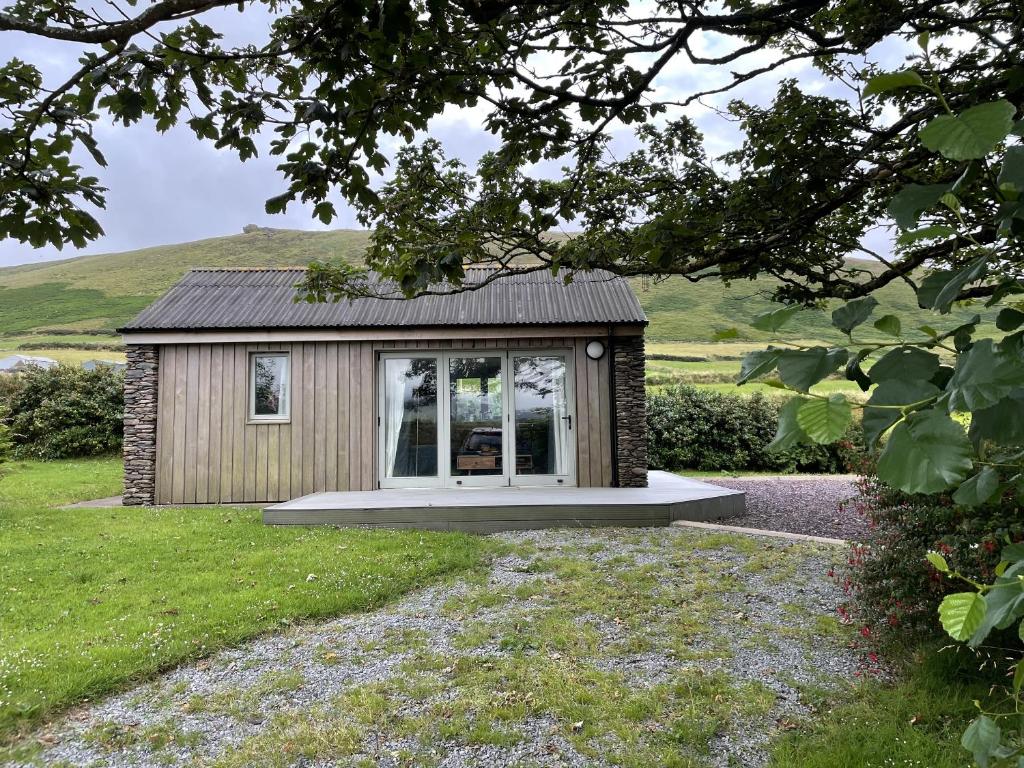 a tiny house with a window in a yard at Bosca Neadu in Dingle