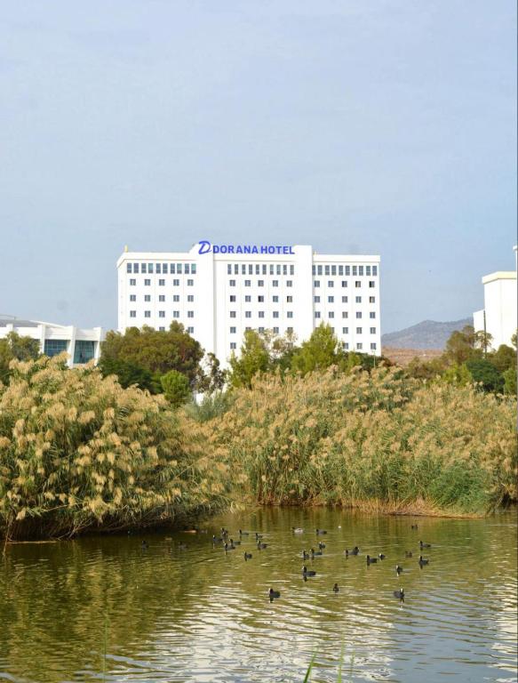 a building with ducks in the water in front at Dorana Hotel Lefkoşa in Lefkosa Turk