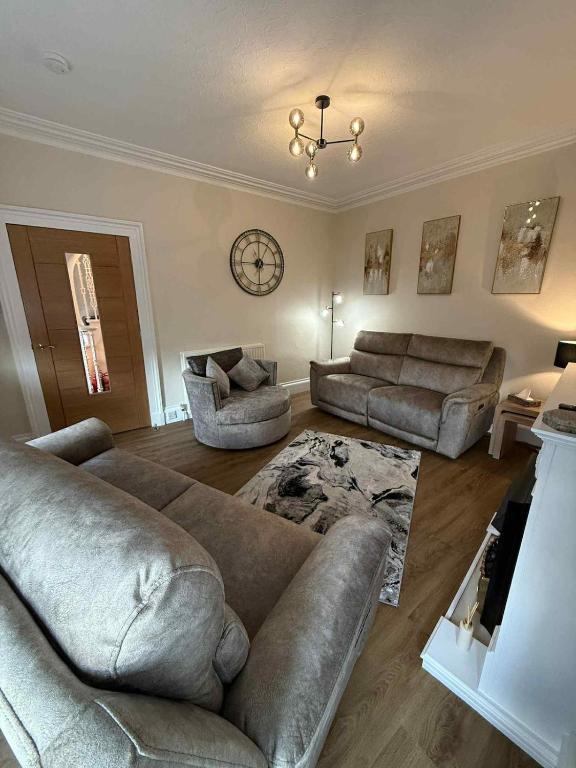a living room with two couches and a couch at Home in Macduff in Macduff