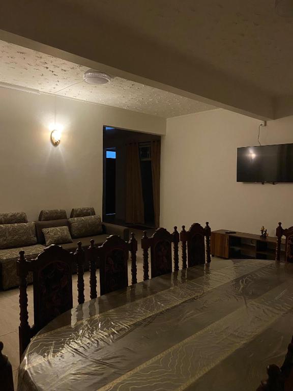 a living room with a couch and a table at Coastal Retreat Penthouse in Pereybere