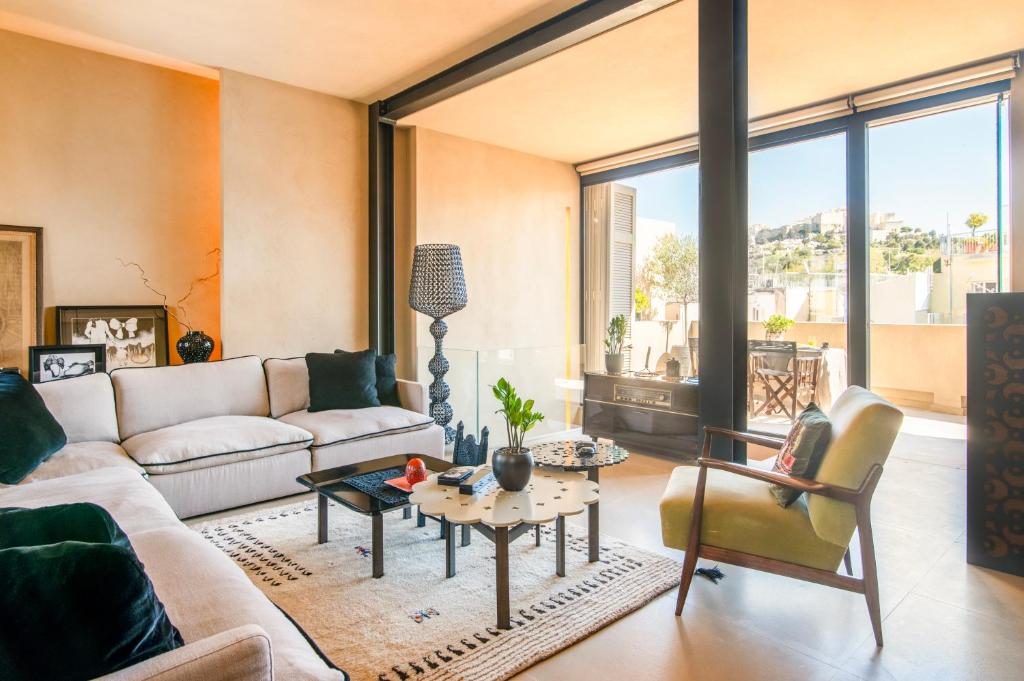 a living room with a couch and a table at Architects Masterpiece Villa with Private Rooftop in Athens