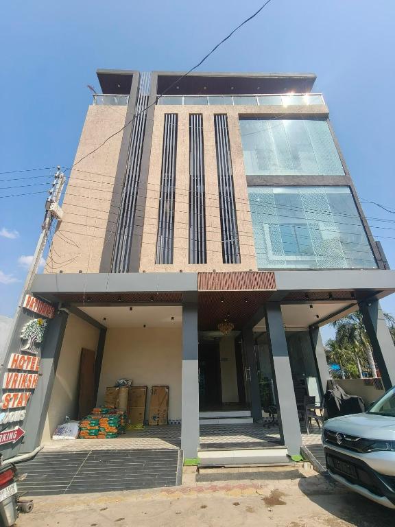 a building with a large window on the front of it at Hotel Vriksh Stay in Godarpura
