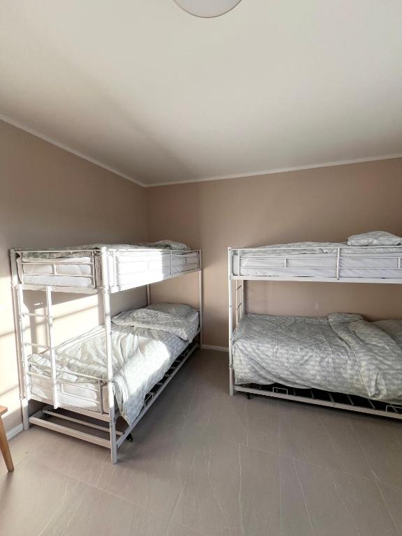 two bunk beds in a room with a ceiling at Pokoje Chojnice in Chojnice